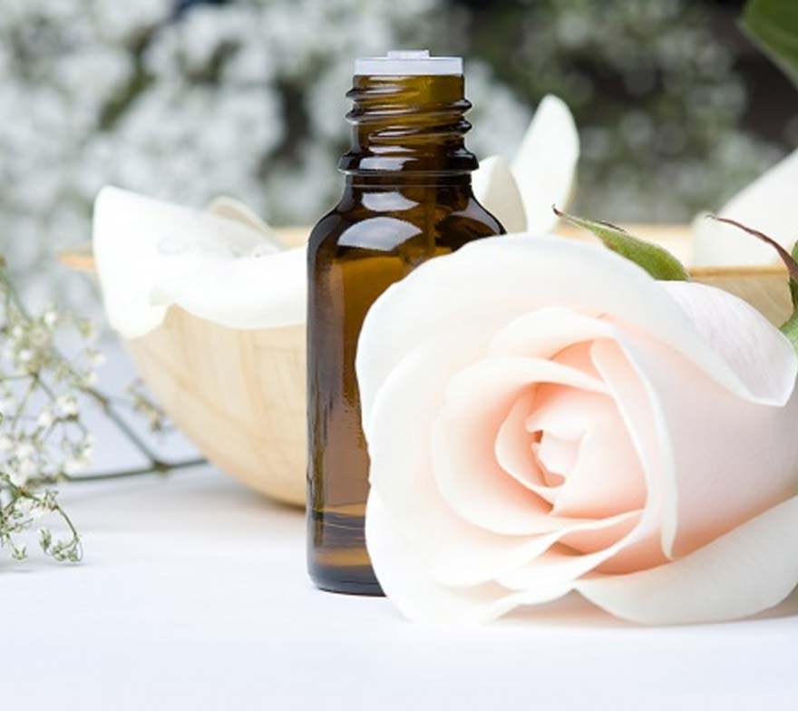 Flower next to essential oils