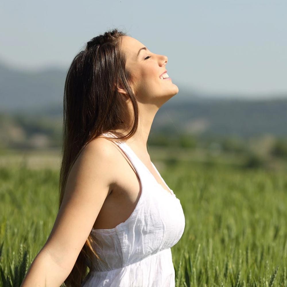 Woman in the fields smiling